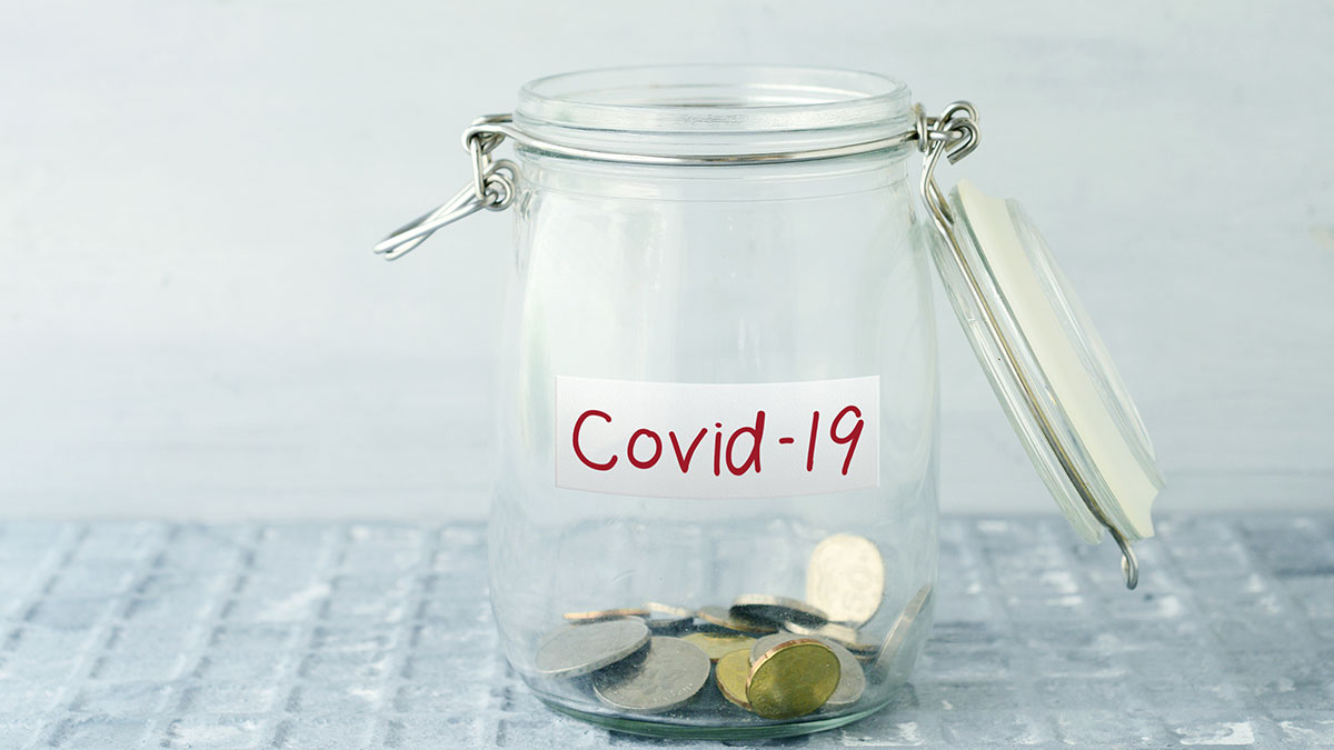 Coins in a jar for COVID emergency fund