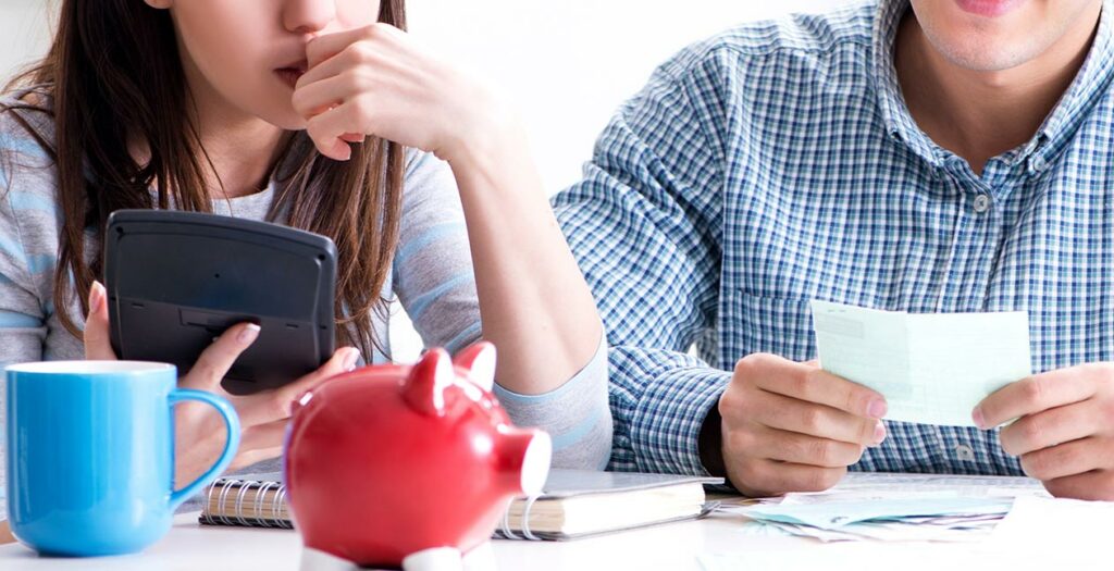 couple filing taxes at a kitchen table