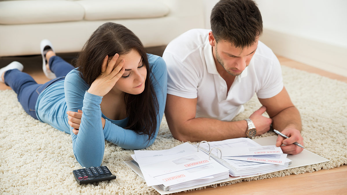 couple creating financial goals on living room rug